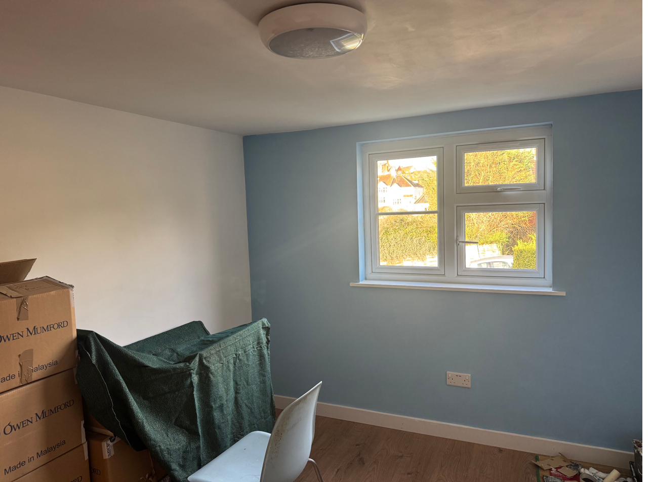 New bedroom inside the dormer, blue walls and a new double window
