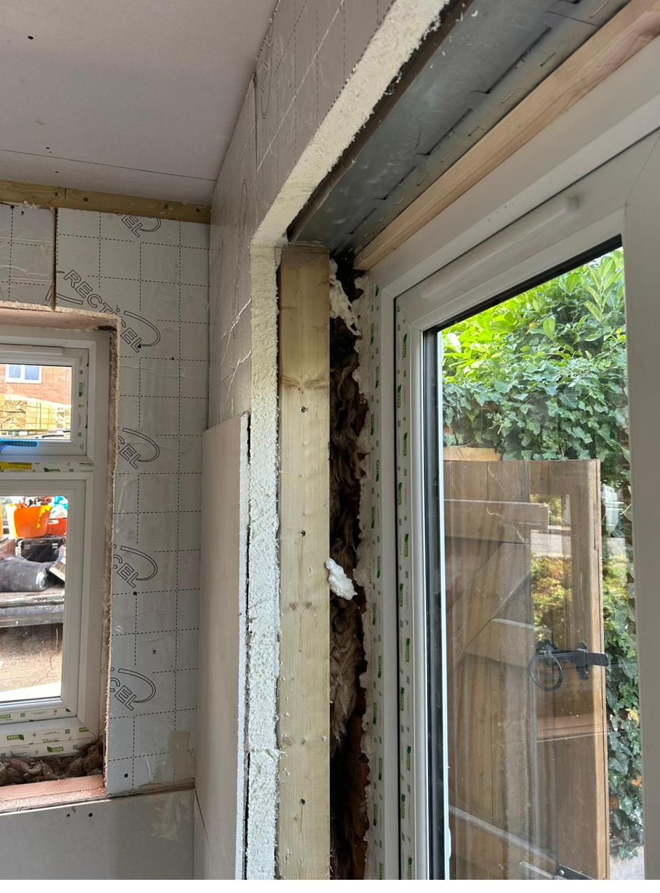 New window and insulation being installed during the garage conversion