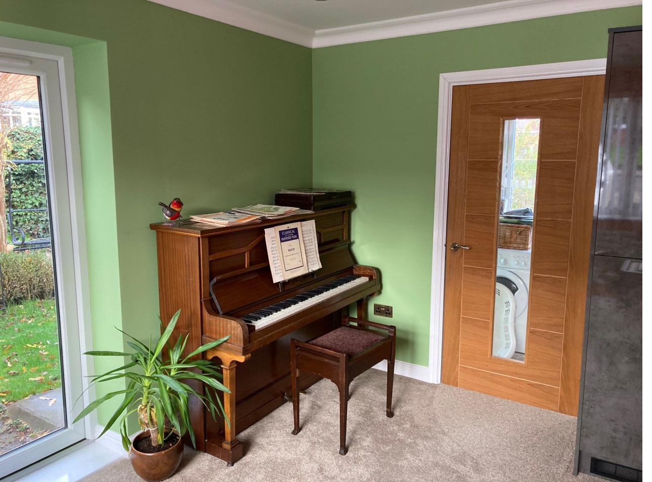 Living room with piano, part of a garage conversion project
